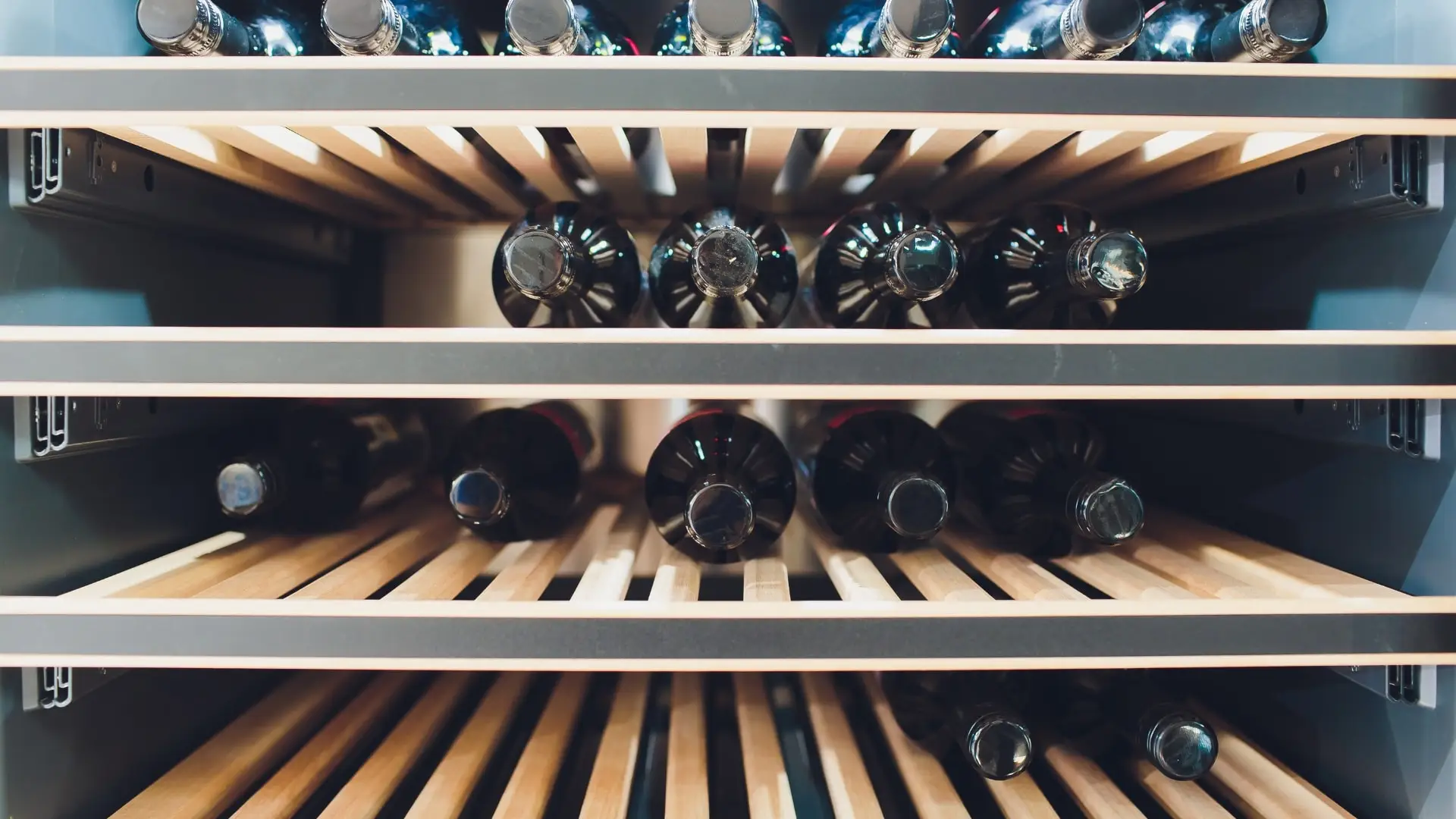 A wine cellar half way filled with wine bottlers.